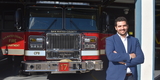 Man in front of fire apparatus